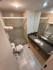 a bathroom with a shower and a toilet and a sink at UNU Congonhas in São Paulo