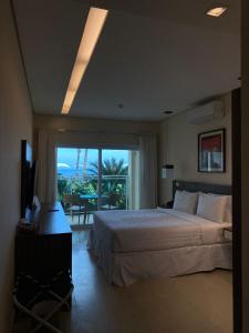 Cama ou camas em um quarto em Amora Hotel Maresias