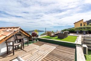 a deck with a view of the ocean from a house at VILLA MARGUERITE VI4406 By Riviera Holiday Homes in Villefranche-sur-Mer