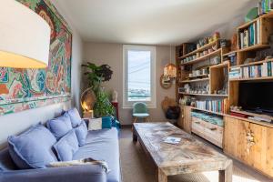 ein Wohnzimmer mit einem blauen Sofa und einem Tisch in der Unterkunft VILLA MARGUERITE VI4406 By Riviera Holiday Homes in Villefranche-sur-Mer