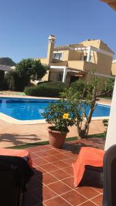 a villa with a swimming pool and a house at La Manga Club Villa in Atamaría