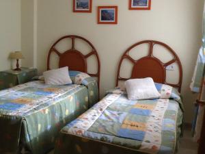 two beds sitting next to each other in a bedroom at La Manga Club Villa in Atamaría +16 photos