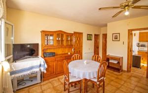 a dining room with a table and a tv at Villa privada a 350 metros del mar ALCOSSEBRE Albert Villas in Alcossebre