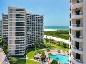 an aerial view of two tall buildings and a swimming pool at Beach Front Condo In Paradise Marco Island in Marco Island