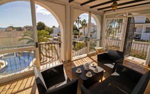 a balcony with chairs and a table with a view of the water at Villa privada a 350 metros del mar ALCOSSEBRE Albert Villas in Alcossebre