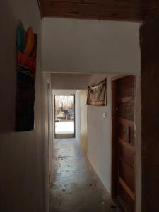 an empty hallway in a house with a door at Hostel Nugeku in Rincón