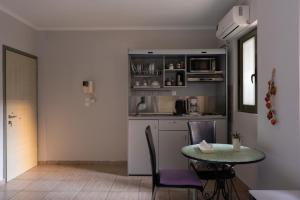 a kitchen with a table and a table and chairs at CENTRAL Studio - Fully equiped. Ideal for couples in Patra
