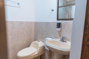 a bathroom with a toilet and a sink at Hotel Don Nino in Oaxaca City +58 photos