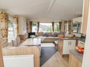 a living room and kitchen of a caravan at Ocean View in Ilfracombe