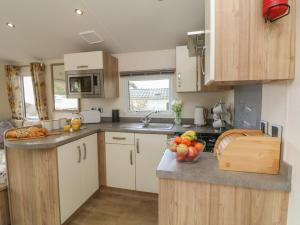 a kitchen with a bowl of fruit on the counter at Ocean View in Ilfracombe +16 photos