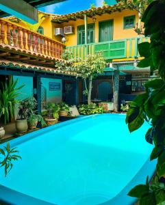 a large swimming pool in front of a house at Pousada Villas Boas Arraial do Cabo in Arraial do Cabo