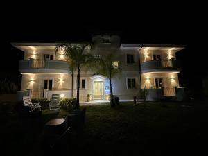 a large white house with lights on it at night at Blue Marine in Tropea