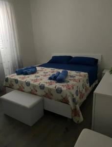 a bedroom with a bed with blue pillows on it at La conchiglia sul mare in Mazara del Vallo