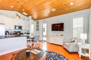 a kitchen and living room with a wooden ceiling at Waterfront Stuart Oasis with Hot Tub and Dock! in Stuart