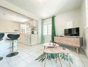 a large living room with a tv and a table at VILLAS AUMIS 2MR in Fort-de-France