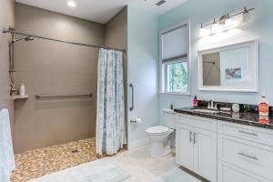 a bathroom with a shower and a toilet and a sink at Waterfront Stuart Oasis with Hot Tub and Dock! in Stuart