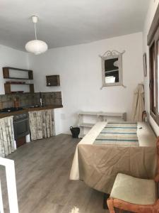 ein weißes Zimmer mit einem Bett und einer Küche in der Unterkunft Fint litet hus i hjärtat av gamla stan och nära hav in Salobreña