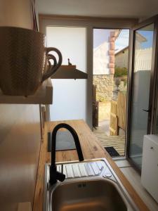a kitchen with a sink and a view of a patio at Apartamento con terraza in San Vicente de la Barquera