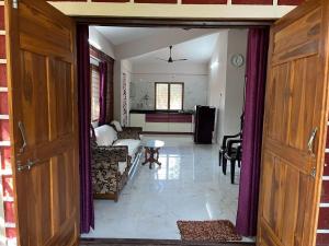 a living room with a couch and a table at Dev Villa Dapoli in Dapoli