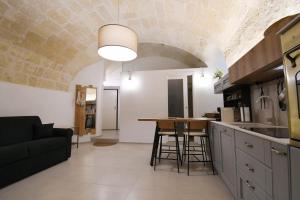 a kitchen with a table in the middle of a room at LA FINESTRA SUL PONTE in Gravina in Puglia