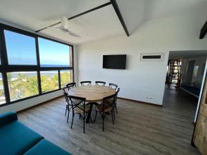 a dining room with a table and chairs at Grand Appartement Mer - Pétrel 1 in Trois Bassins