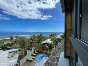 a view of the ocean from a balcony of a resort at Grand Appartement Mer - Pétrel 1 in Trois Bassins