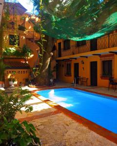 a swimming pool in the courtyard of a house at Boutique Colonial House Hotel in Santo Domingo