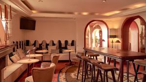 a restaurant with tables and chairs in a room at Hotel Fortaleza do Guincho Relais & Châteaux in Cascais