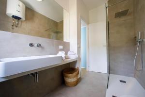 a bathroom with a sink and a shower at Villetta Acacie in San Vito lo Capo