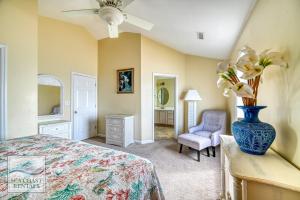 a bedroom with a bed and a vase with flowers at Paradiso a Mare in North Topsail Beach