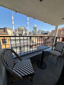 a balcony with chairs and a view of a city at Marlon Hotel in Istanbul