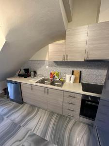a kitchen with white cabinets and a sink at Lajes Apartment in Skala Potamias