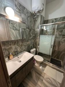 a bathroom with a sink and a toilet at Lajes Apartment in Skala Potamias +19 photos