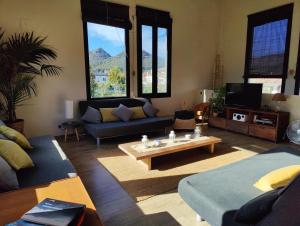 a living room with a couch and a coffee table at Cal Gat in Les Planes d'Hostoles
