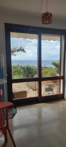 a room with a large window with a view of the ocean at Villa 1974 in Saint-Raphaël