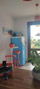 a kitchen with a table and two chairs and a refrigerator at Villa 1974 in Saint-Raphaël