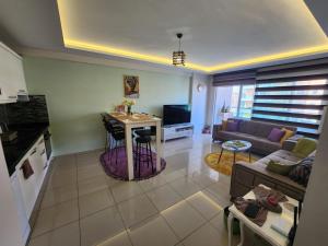 a living room with a couch and a table at Cozy fancy Sea view next to the Beach and the Mall, in the mid of Alanya Mahmutlar! in Alanya