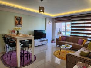 a living room with a couch and a table at Cozy fancy Sea view next to the Beach and the Mall, in the mid of Alanya Mahmutlar! in Alanya