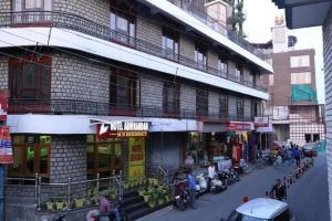 a group of people standing outside of a building at Hotel Abhinandan Mussoorie Near Mall Road - Parking Facilities & Prime Location - Best Hotel in Mussoorie in Mussoorie