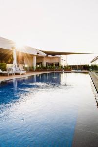 a large swimming pool in front of a building at Luxury Menlyn Maine Apartment in Pretoria