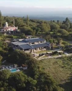 an aerial view of a large house in the forest at Establecimiento La Soleada suites de campo in La Cumbre
