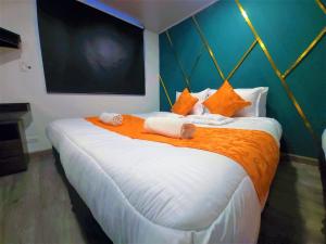 a bedroom with a large bed with towels on it at Hotel Kristal Ferial in Bogotá