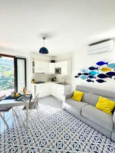 a living room with a bed and a table at Panoramic Flat Amalfi Coast - Sea View 1 in Vietri sul Mare +50 photos