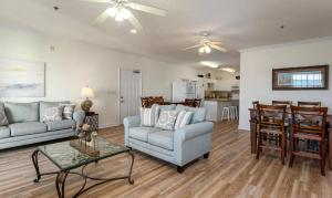 a living room with a couch and a table at Stunning and Spacious 5 BR Condo- With Ocean Views and more! Cherry Grove Villas 402 in Myrtle Beach