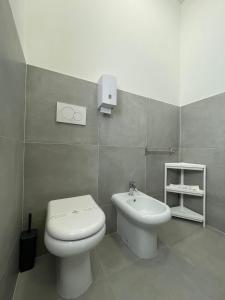 a bathroom with a white toilet and a sink at Trastevere Station Sweet Rest in Rome