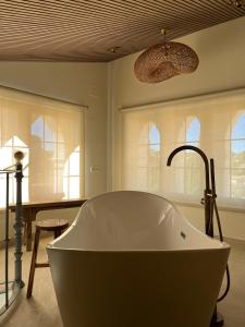a large bath tub in a bathroom with windows at Hotel Finca La Mixtura, Restaurant Mélange in Ontinyent