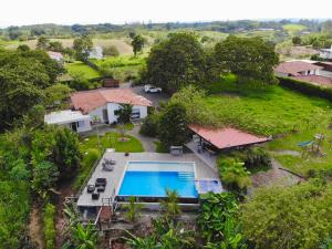 an aerial view of a house with a swimming pool at ORIGEN FINCA HOTEL in Quimbaya