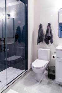 a bathroom with a toilet and a glass shower at Luxury Apartment Private Terrace in Chicago
