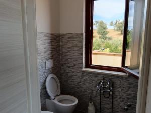a bathroom with a toilet and a window at Villa Rita in Corigliano Calabro +45 photos