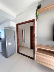 an empty kitchen with a refrigerator in a room at Flat Canoa Quebrada in Aracati